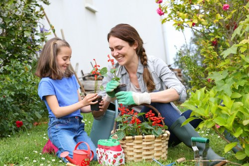Gardener preparing lawn mower before starting Shoreditch lawn mowing job